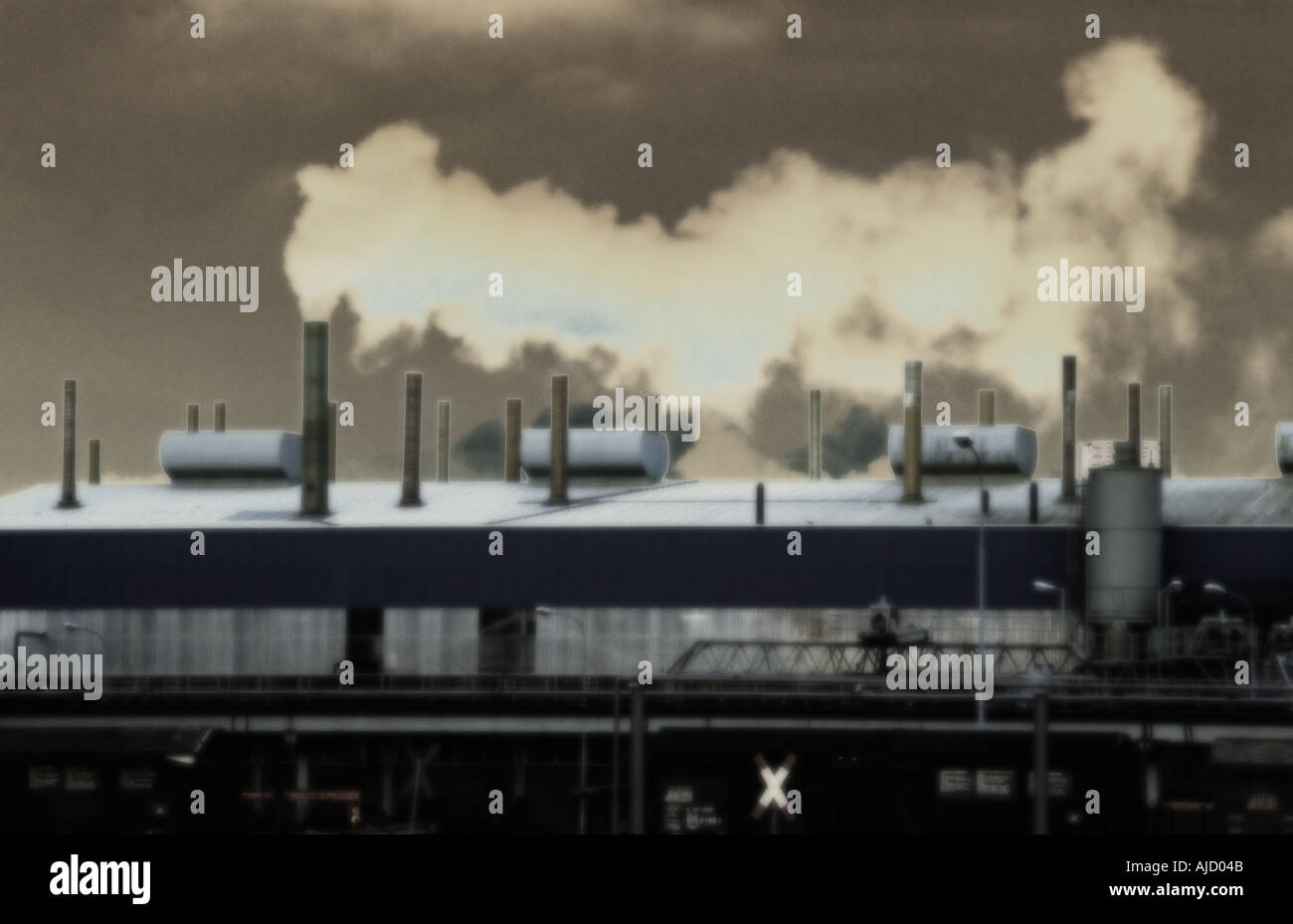 Conceptual image of old factory emitting polluting smoke from a chimney. Stock Photo