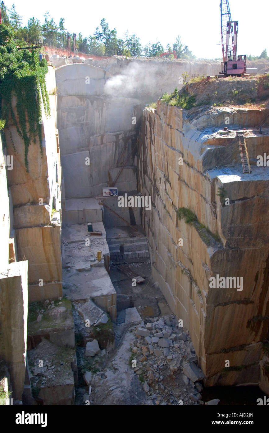 Workers drilling and cutting blocks at a granite quarry in Elberton