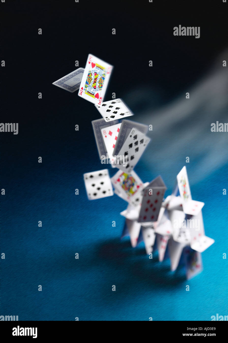 tower of playing cards blown down concept Stock Photo