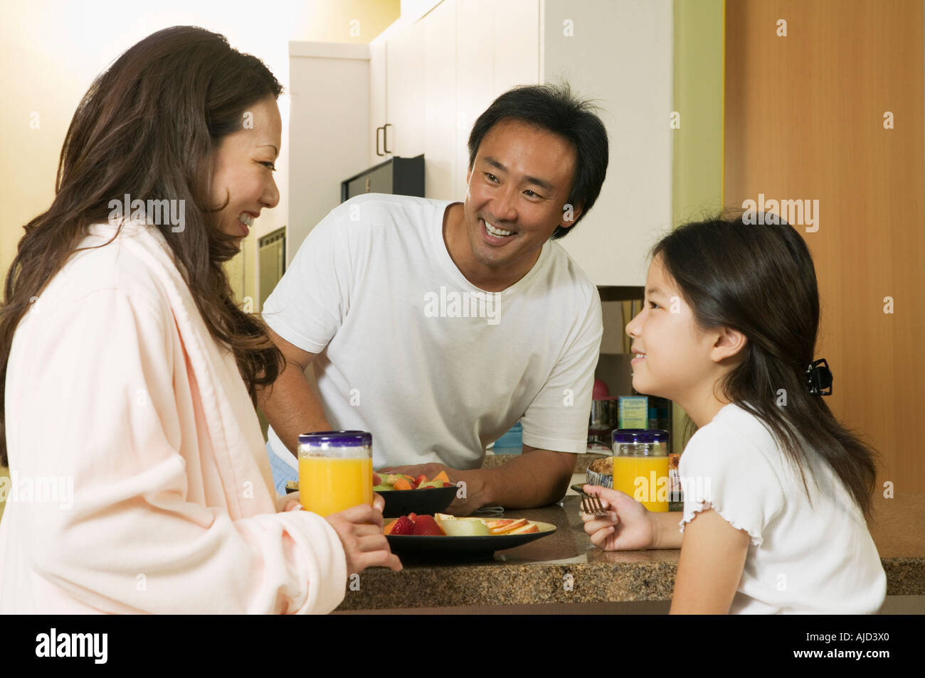 Family Enjoying Breakfast in kitchen Stock Photo