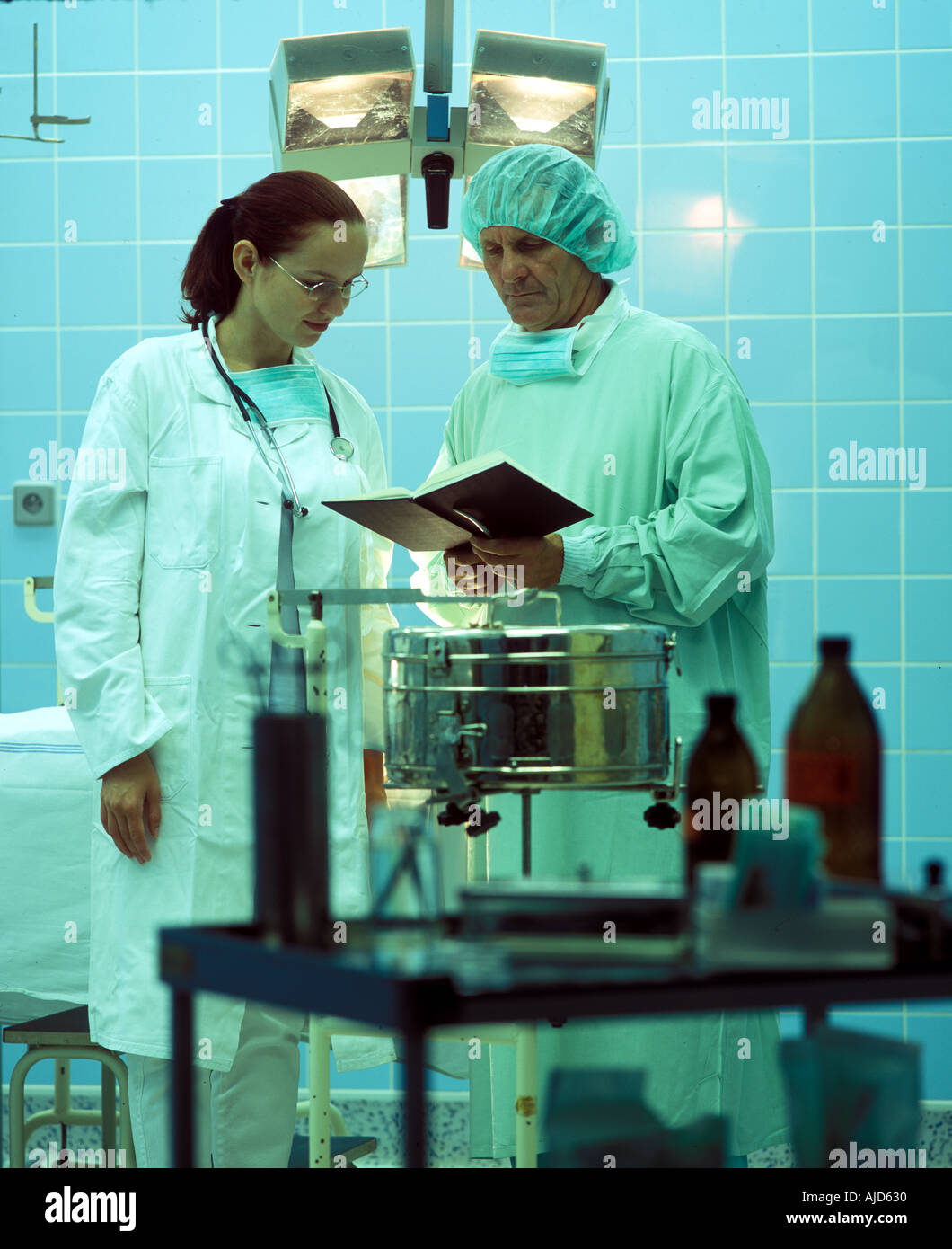 Two Doctors Looking at A Book Stock Photo Alamy