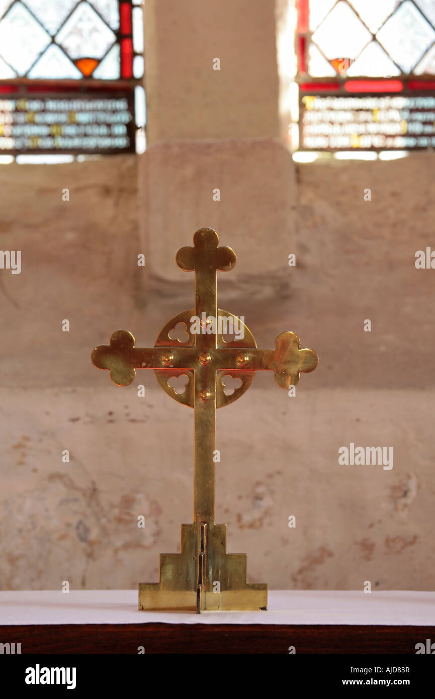 Brass wheel head cross on altar at St Botolph's Church, Hardham, West Sussex, England. UK Stock Photo