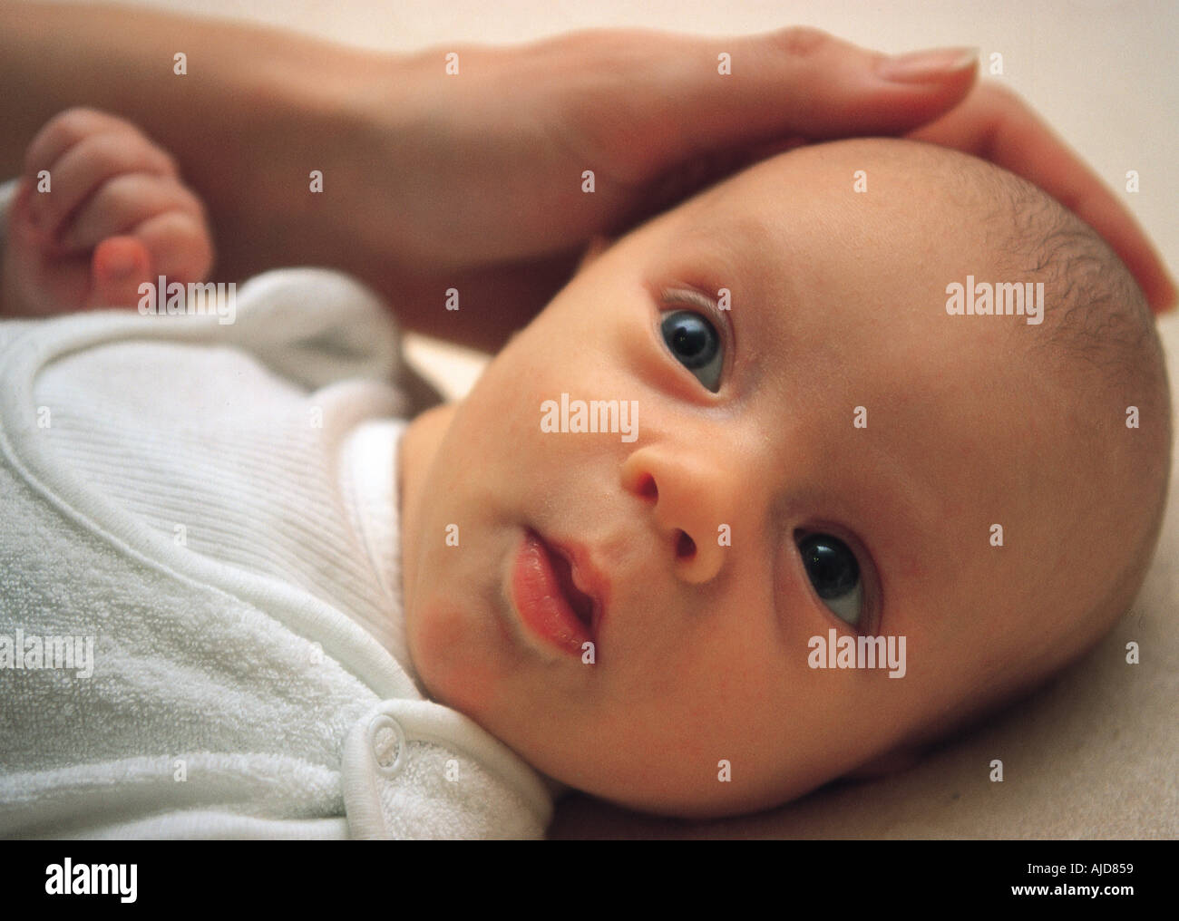 Baby in white Stock Photo - Alamy