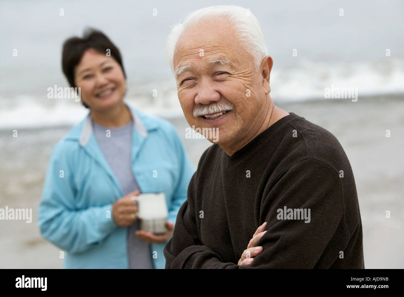Japan, Tokyo Prefecture, Senior couple smiling, focus on man's hand ho...