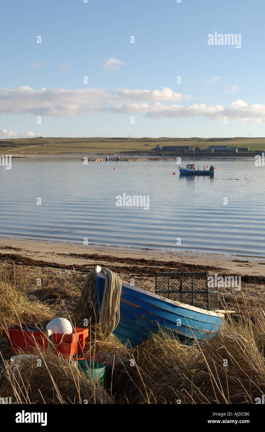 dh  WEDDELL SOUND ORKNEY Fishing boat beaching on Glimps Holm fish boats beach uk beached calm peaceful scene bay scotland beaches Stock Photo