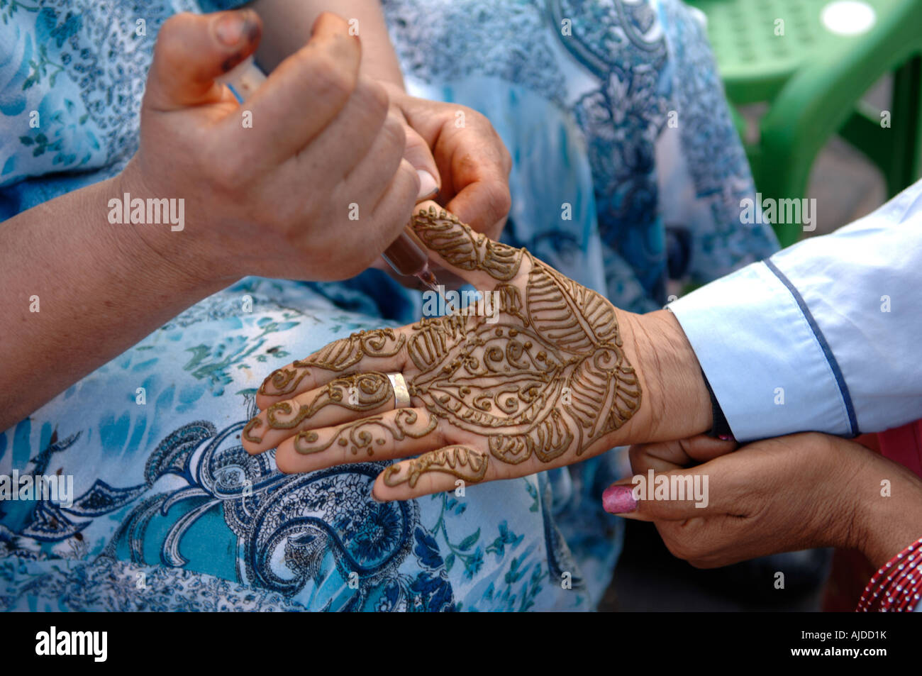 Berber woman having henna tattoo DjemaaelFna Marrakech Morocco