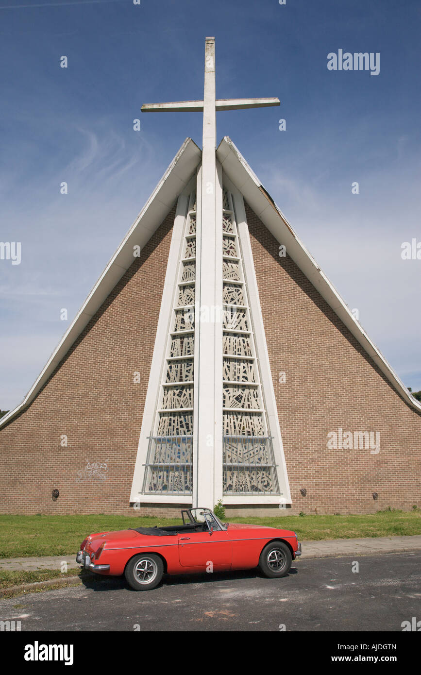 MGB Roadster sports car in red with the hood down, 1972, parked outside a modern church in Sheffield Stock Photo