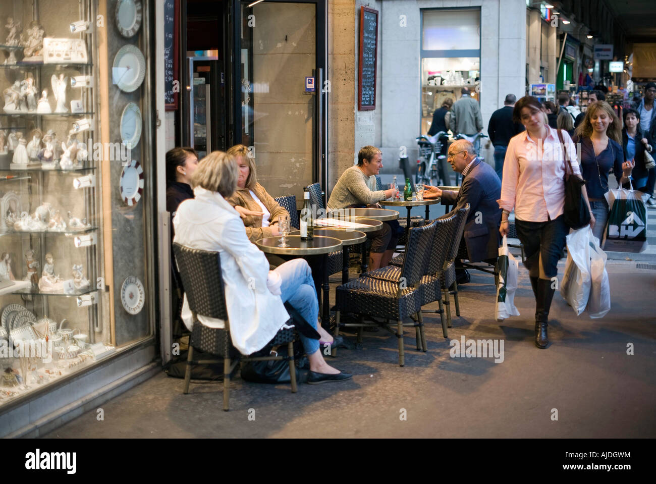 Shoppers and bistro customers in the Rue de Rivoli arcades, next to the Louvre Museum. Stock Photo
