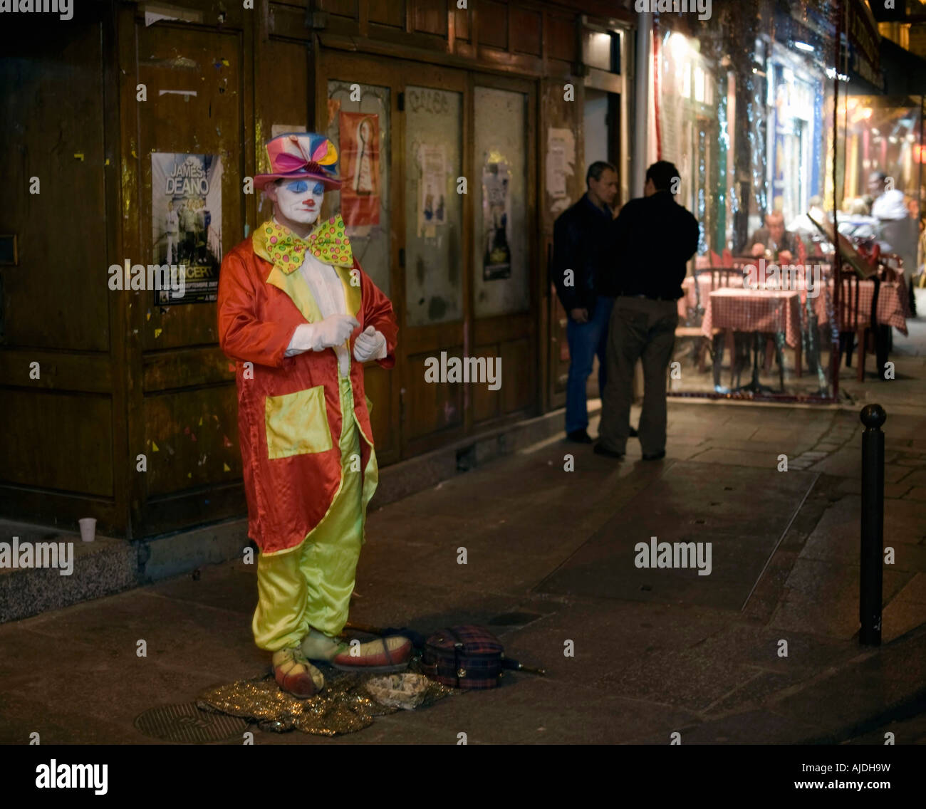 Street performer and entertainer dressed as a clown in Saint Michel a famous tourist destination for dining and entertainment o Stock Photo