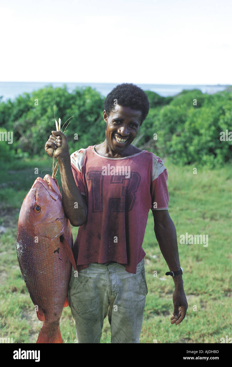 African fisherman offering fish for sale Kenya coast East Africa Stock Photo