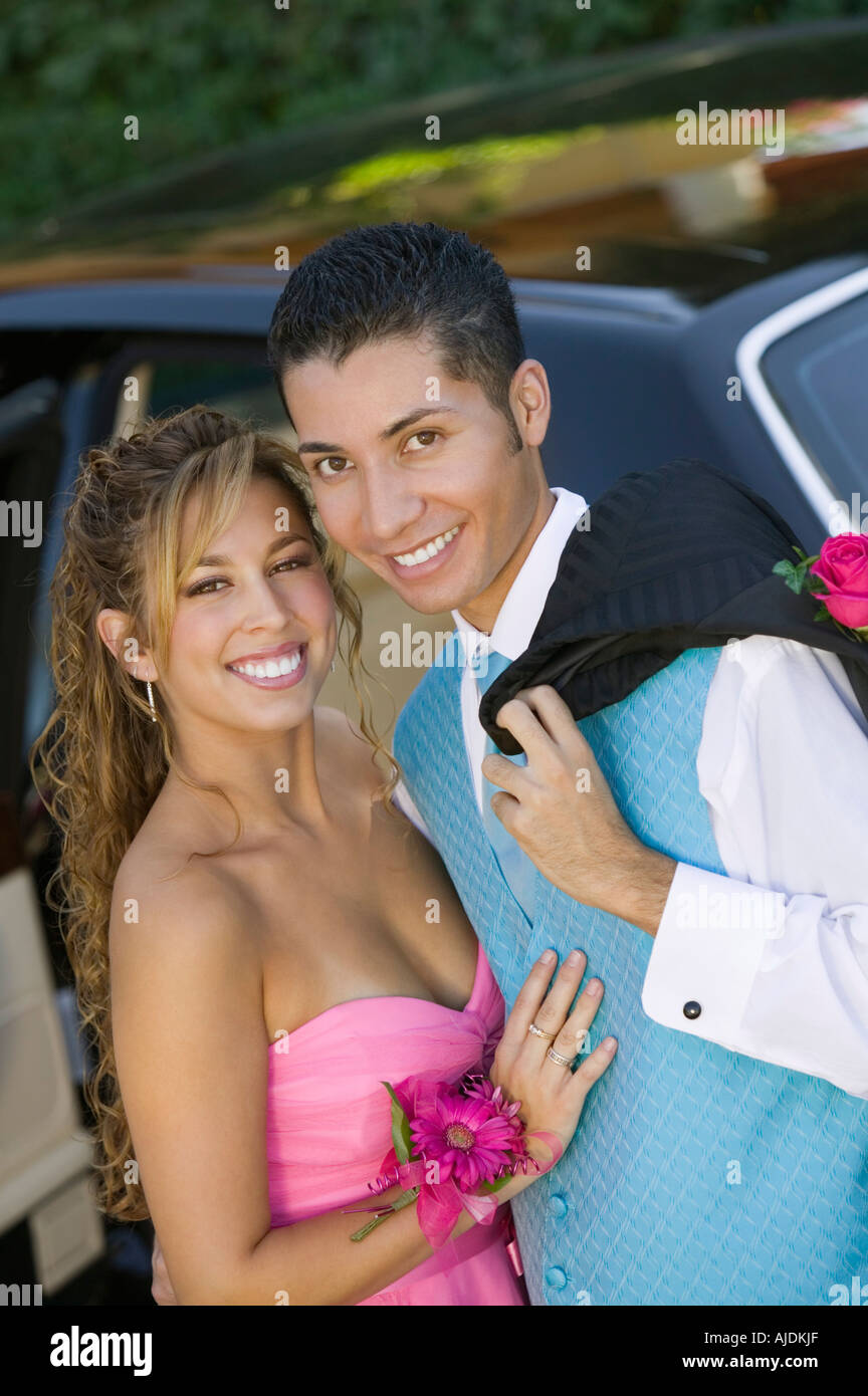 Well dressed teenage couple outside limo, portrait Stock Photo