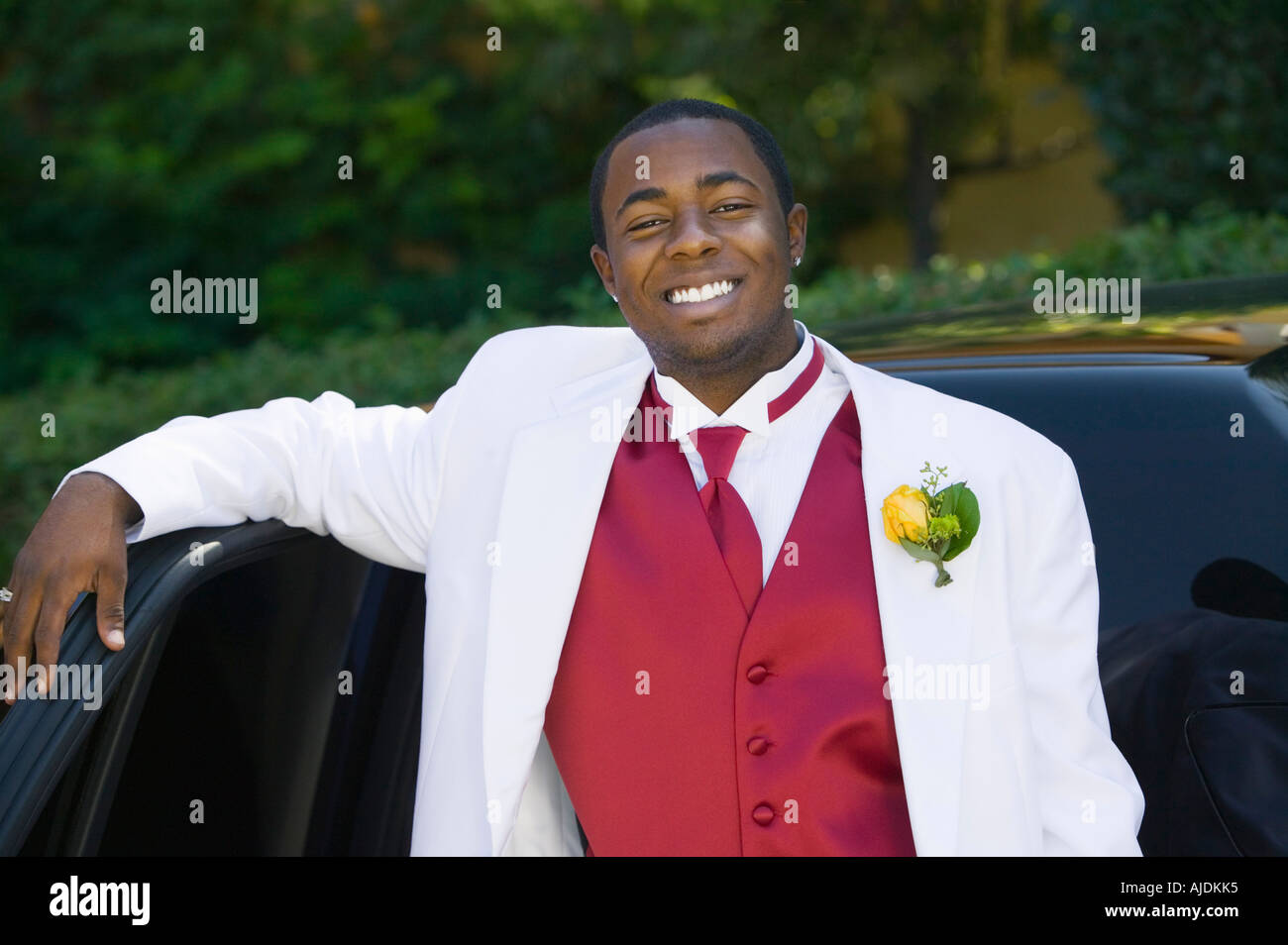 Teenage Boy in suit leaning on limo, portrait Stock Photo