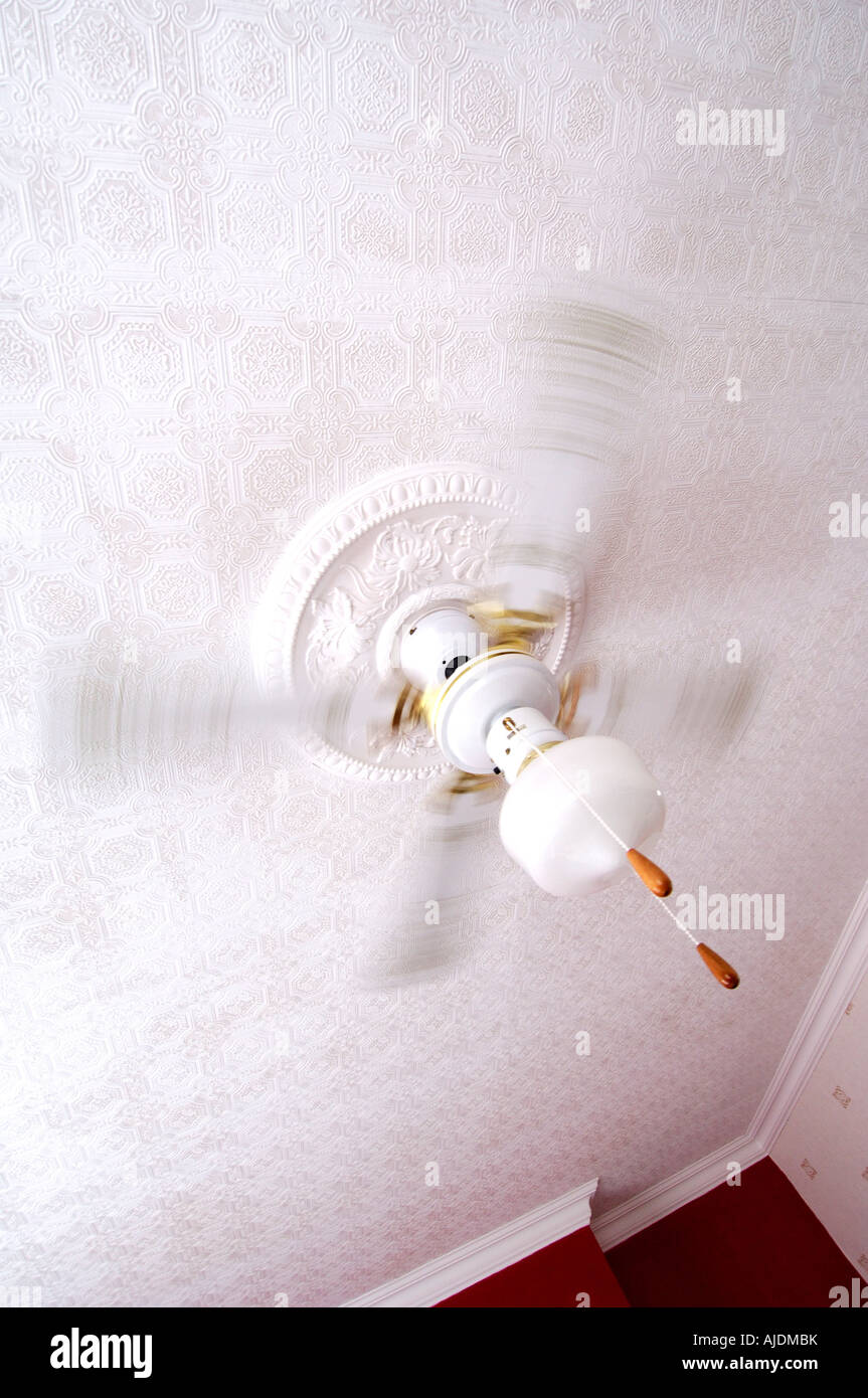 White Ceiling Fan With Built In Light Fitting On A Period White Ceiling Fan With Built In Light Fitting On A Period Textured Patterned Surface Blades Turning