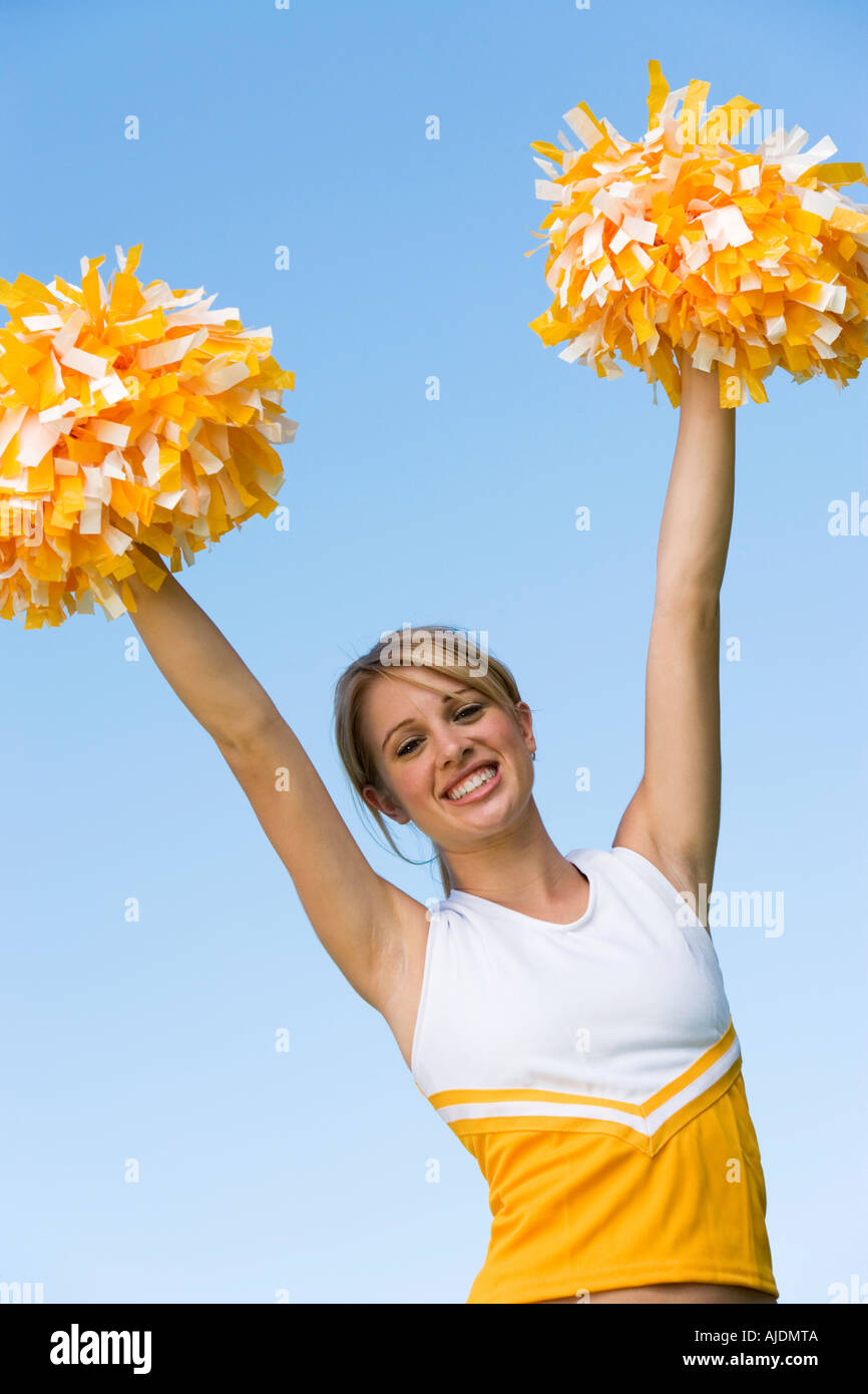 Smiling Cheerleader Rising Pom Poms Portrait Low Angle View Stock Photo Alamy
