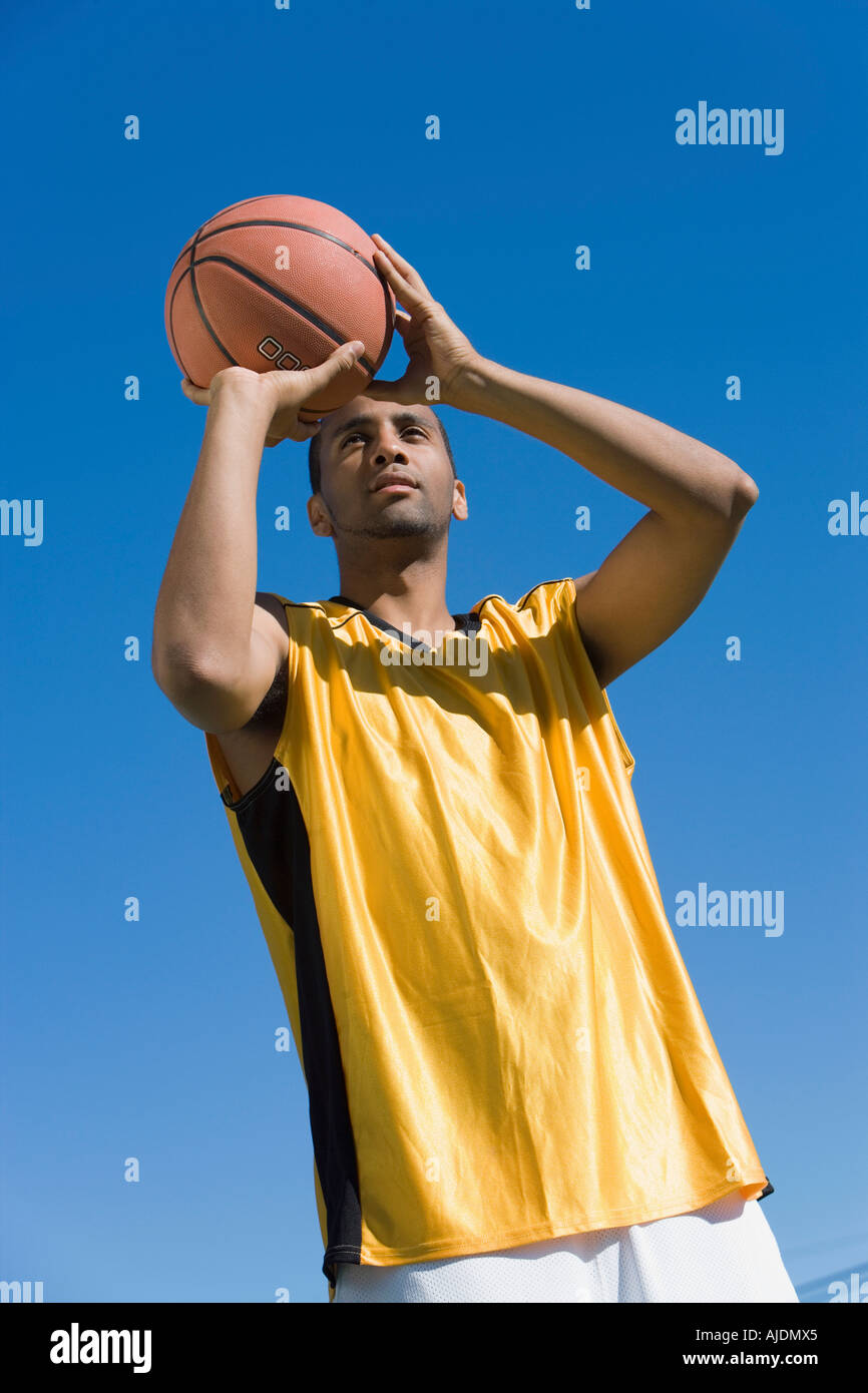 Young Man Shooting Basketball, Portrait, Low Angle View Stock Photo - Alamy