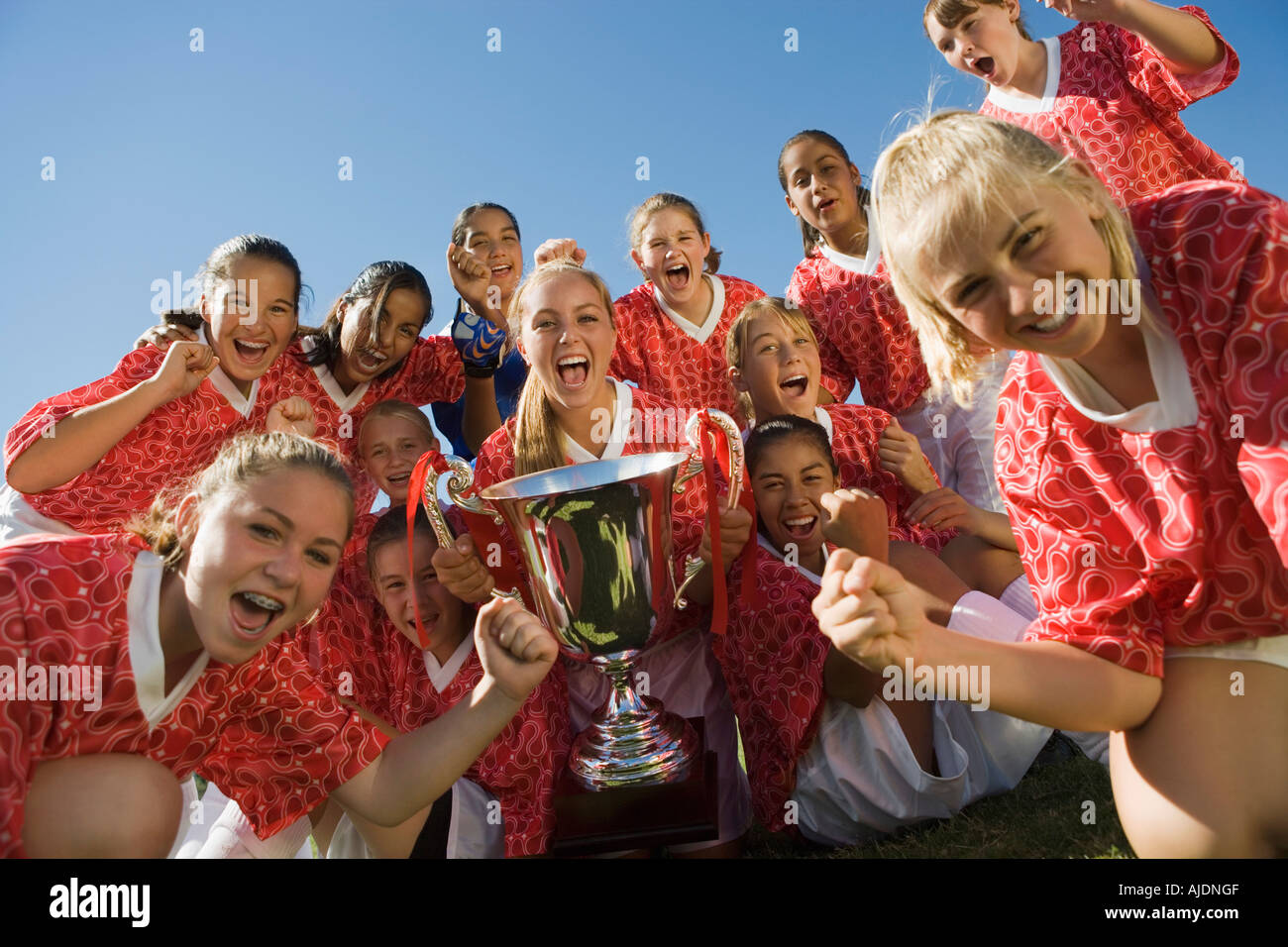 Girls' soccer team (13-17) holding trophy Stock Photo