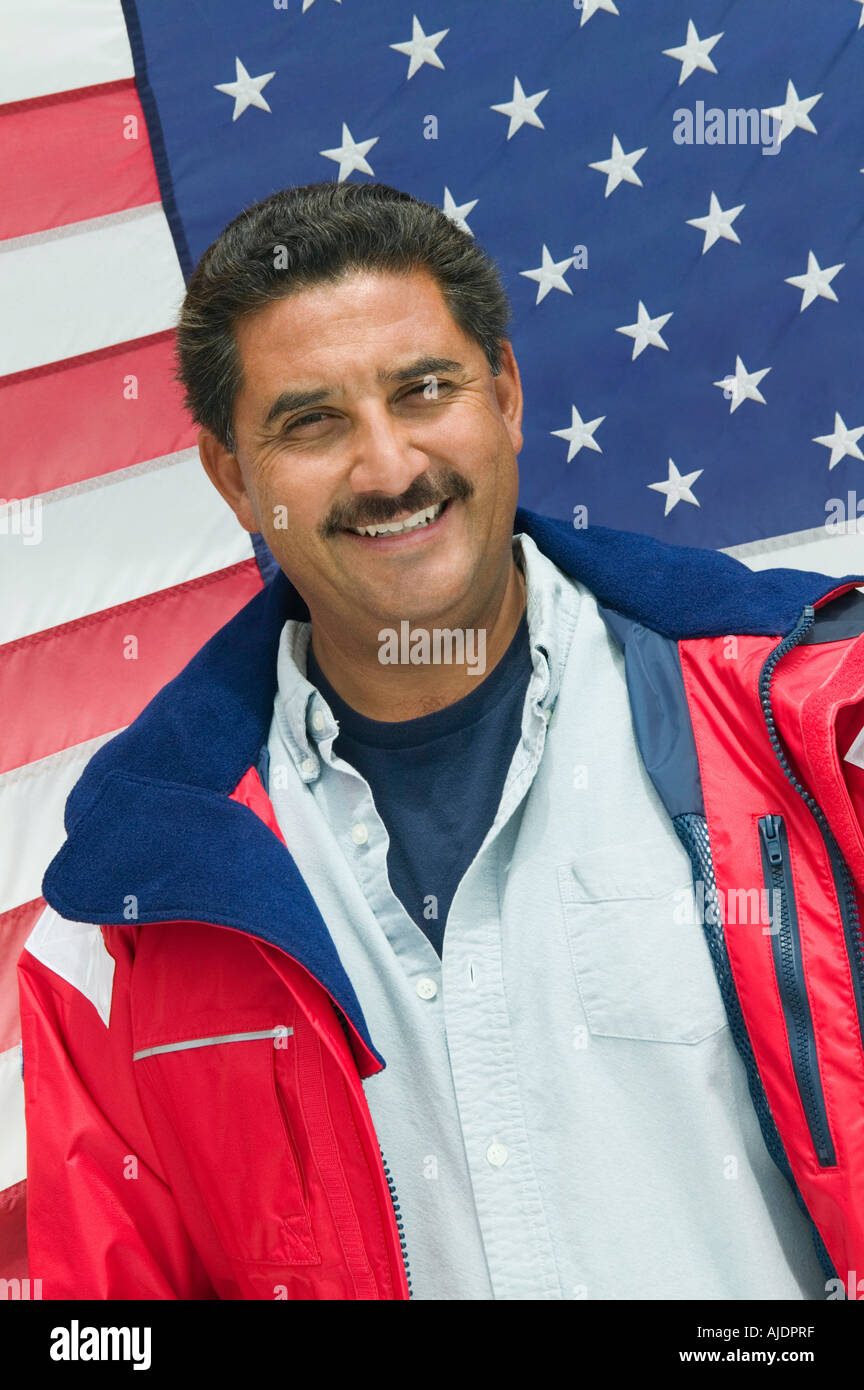 Man standing in front of American flag, (portrait) Stock Photo