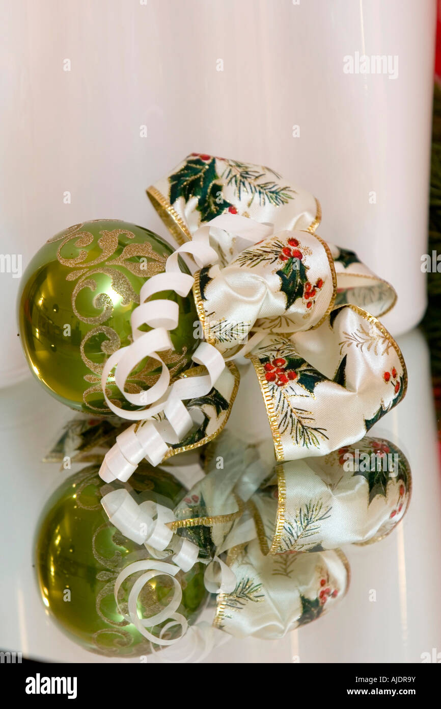 A traditional christmas decoration christmas ball with christmas bow tied to it pine branch copy space Stock Photo