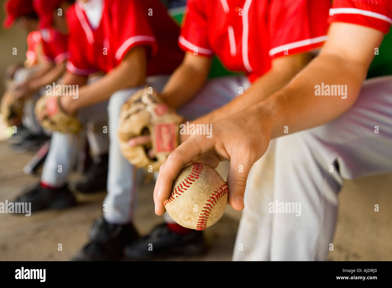 Baseball team-mates sitting in dugout, (low section Stock Photo - Alamy