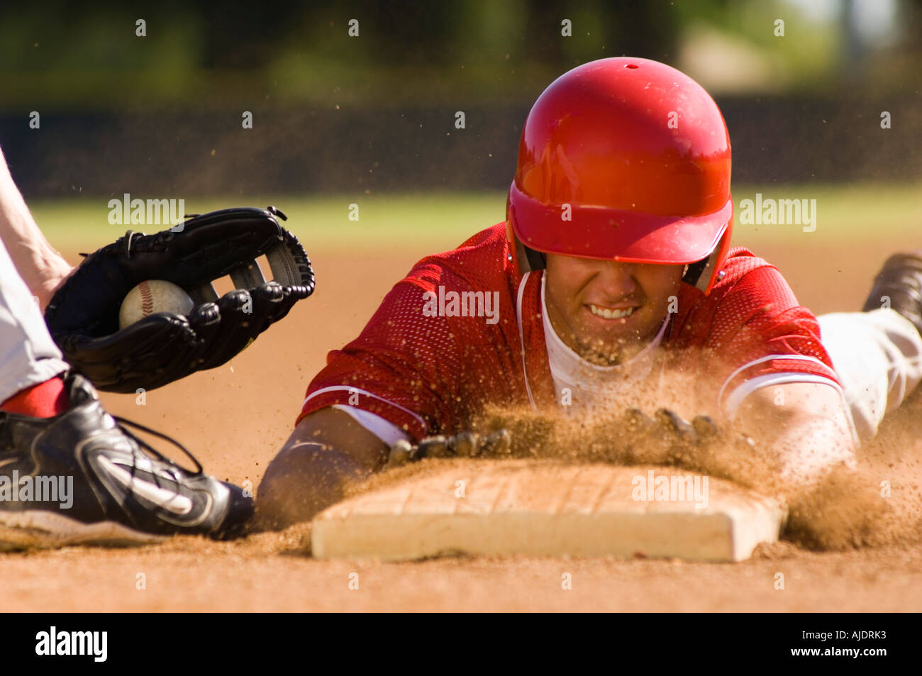 Baseball player sliding into base Stock Photo - Alamy