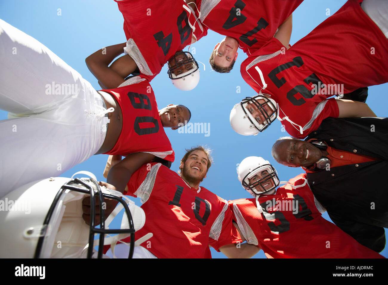 Football Players and Coach in Huddle, view from below, (view from below ...