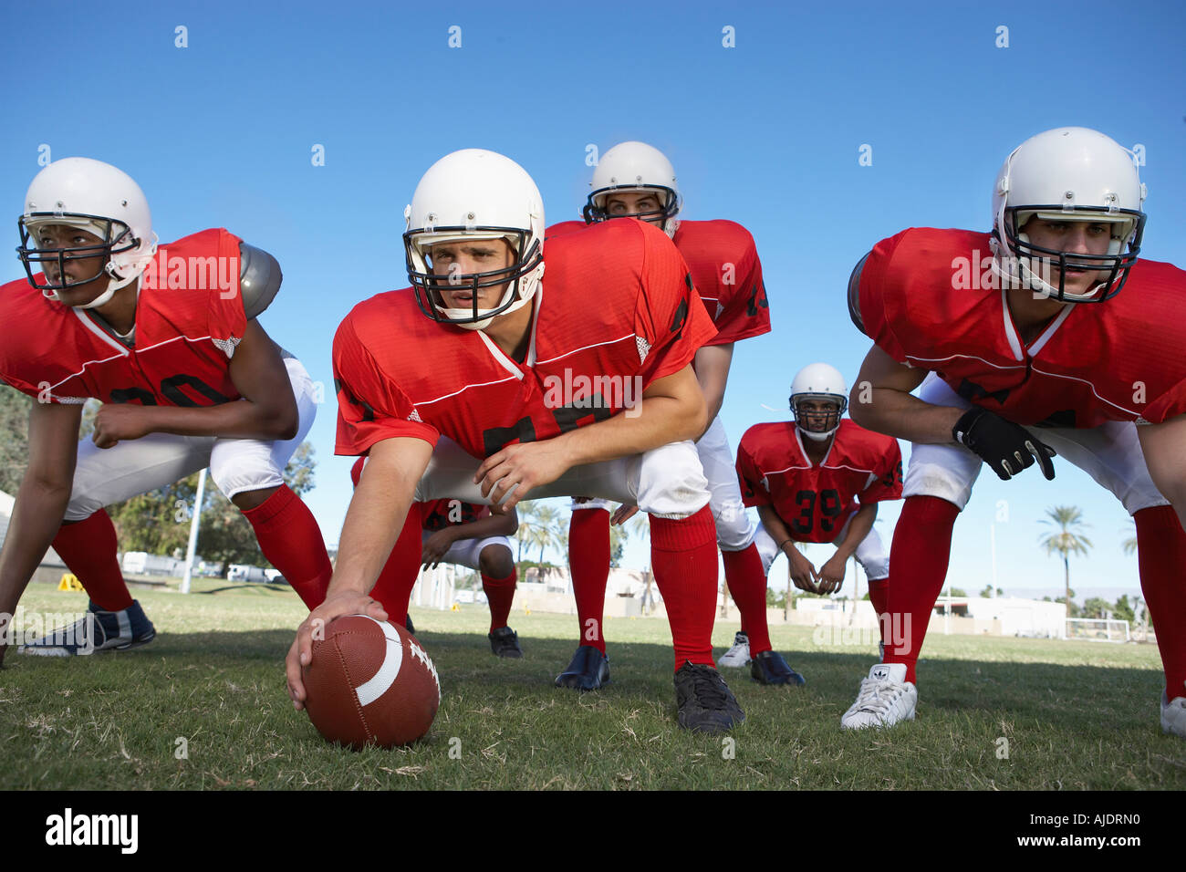 Centre quarterback ready hike football hires stock photography and