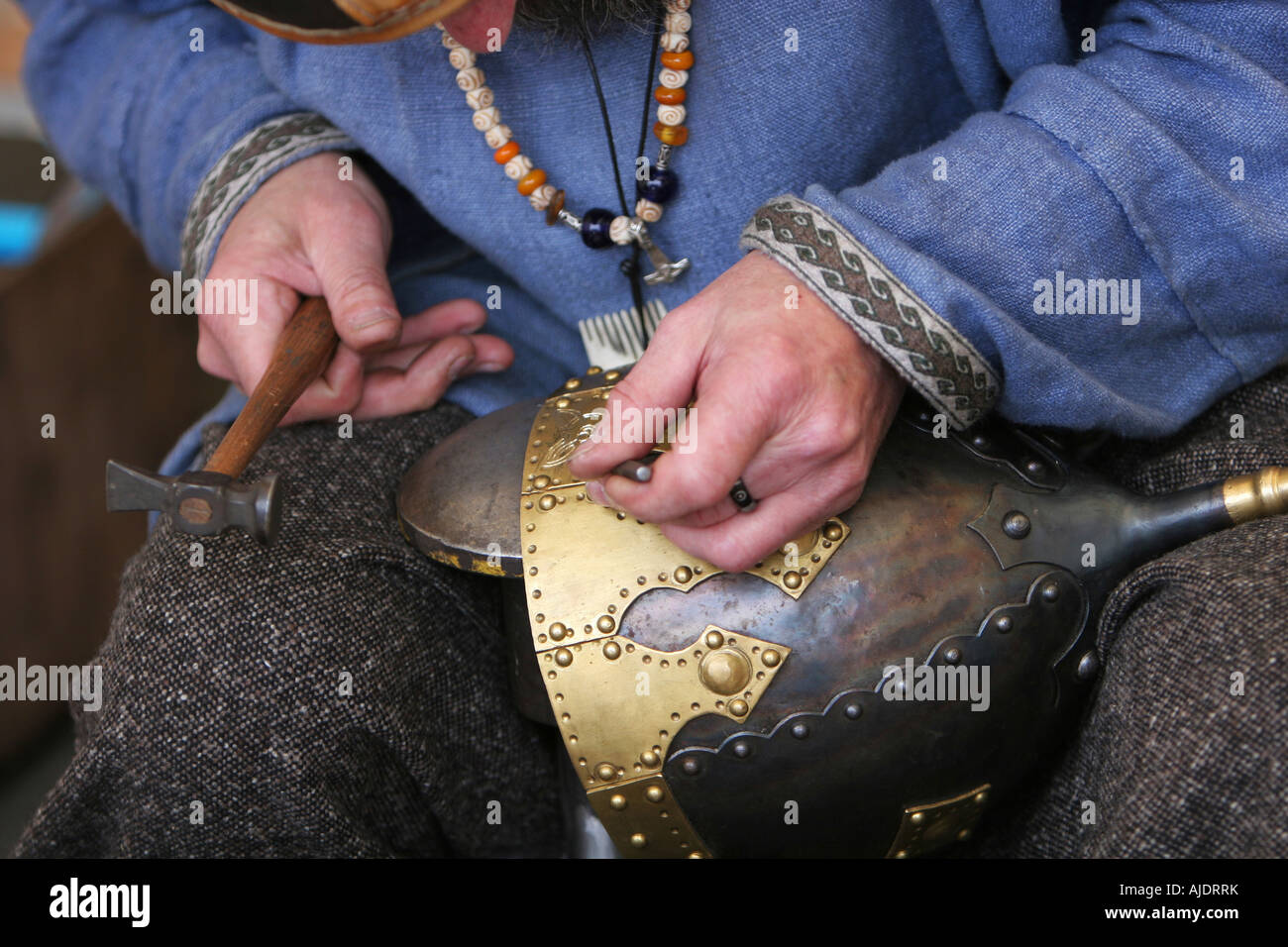 A craftsman making a medieval soldiers helmet the oldfashioned way Stock Photo