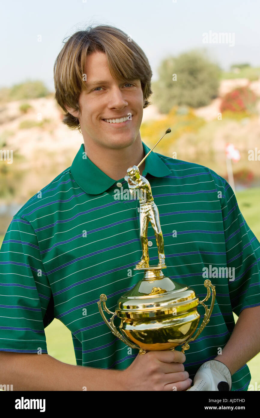Golfer holding trophy Stock Photo Alamy