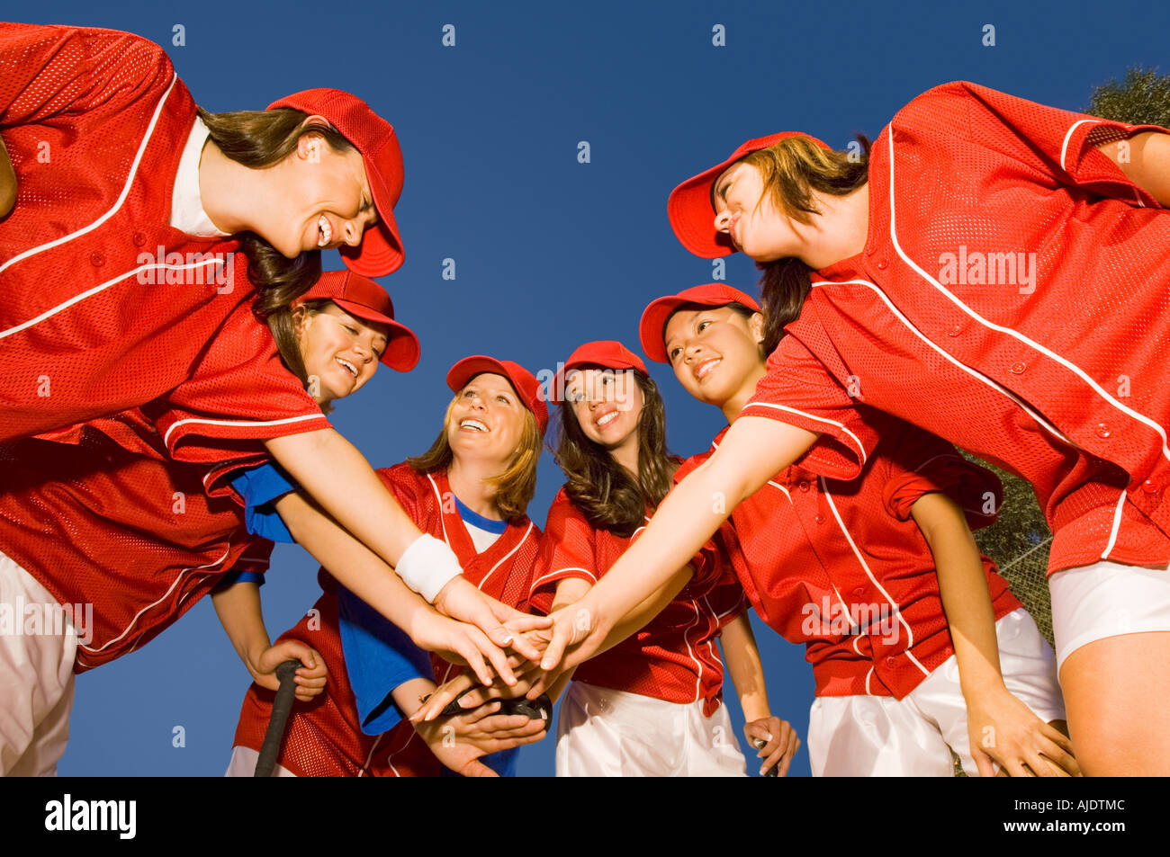 Women's softball team in huddle, low angle view Stock Photo