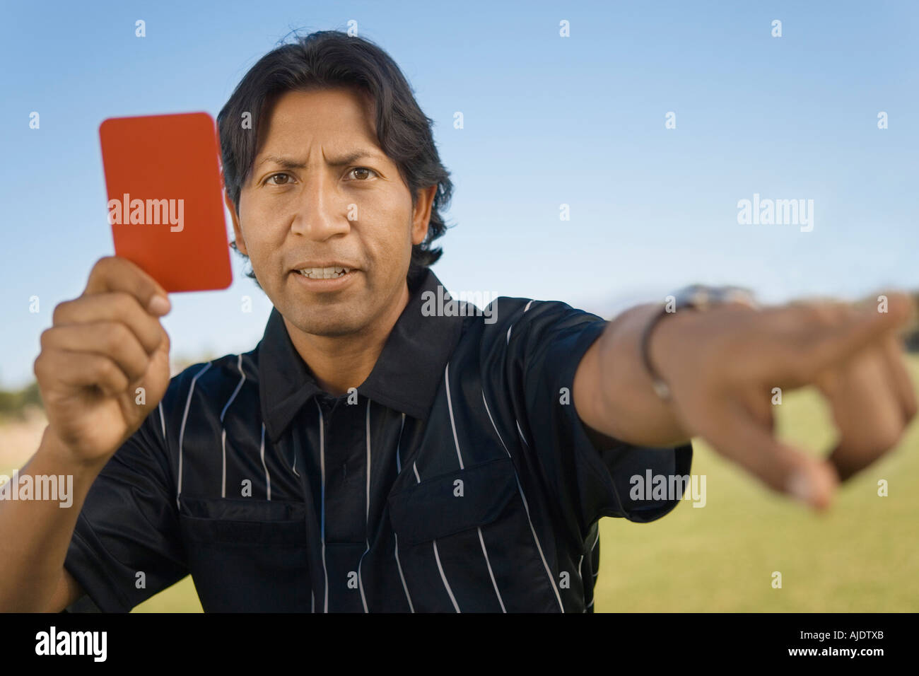 Referee holding up red card and pointing, portrait Stock Photo Alamy