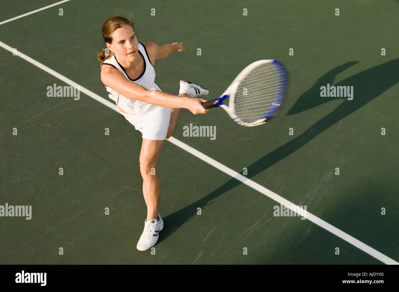 Tennis Player swinging racket in Forehand motion Stock Photo - Alamy