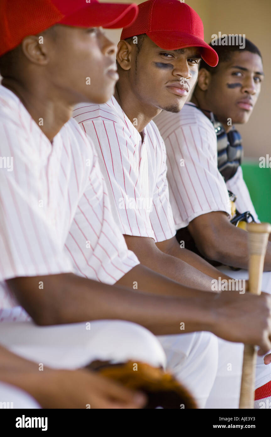 Baseball players sitting in dugout Stock Photo Alamy