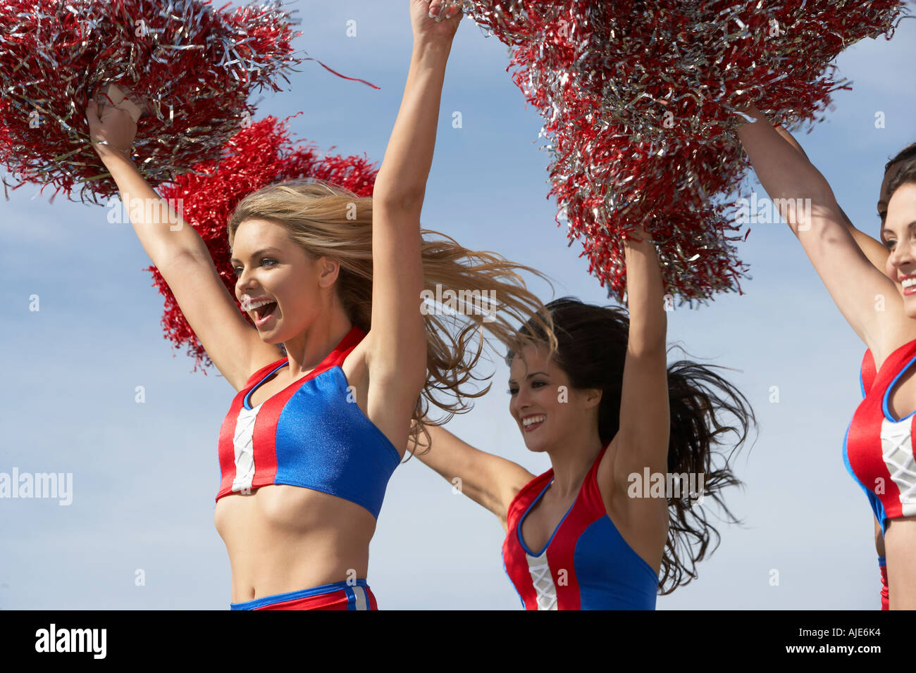 Cheerleaders in Uniform Holding Pom-Poms Stock Photo - Alamy