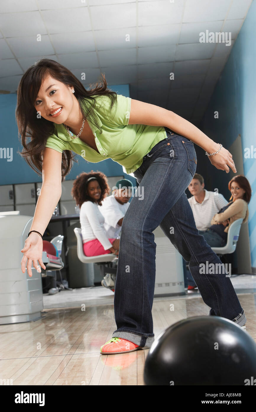 Young woman releasing bowling ball, portrait Stock Photo Alamy