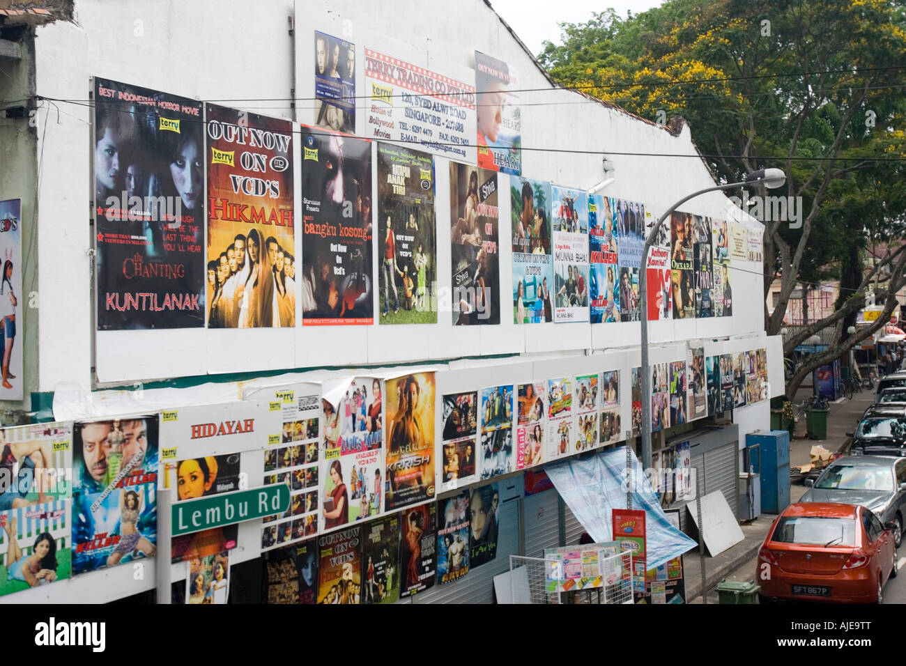 Film posters on wall promoting Indian movies Little India Singapore Stock Photo