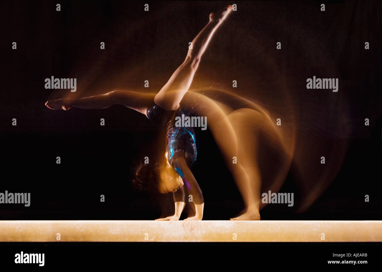 Multiple exposure image of female gymnast in motion on balance beam Stock Photo