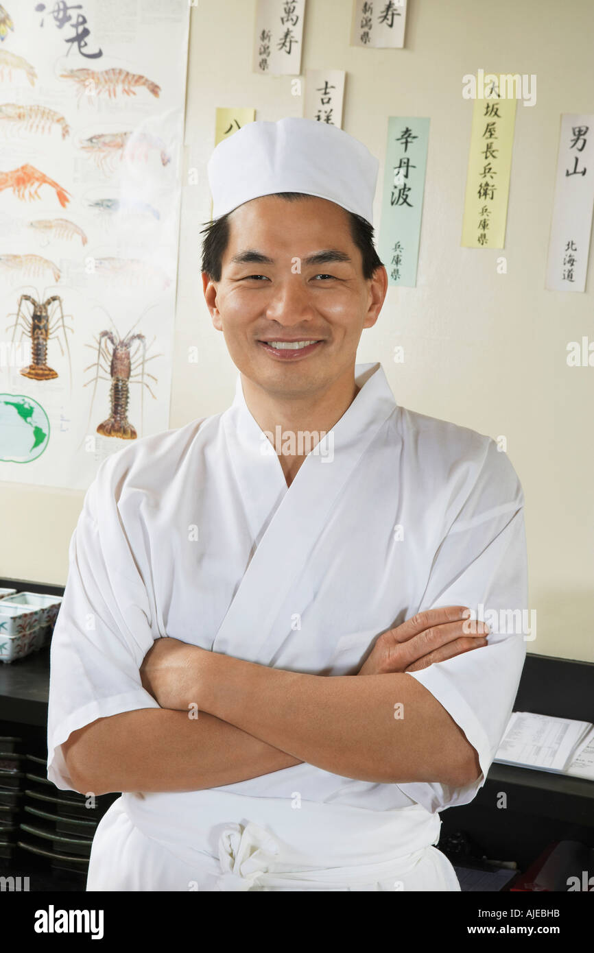 Sushi chef standing in restaurant Stock Photo Alamy