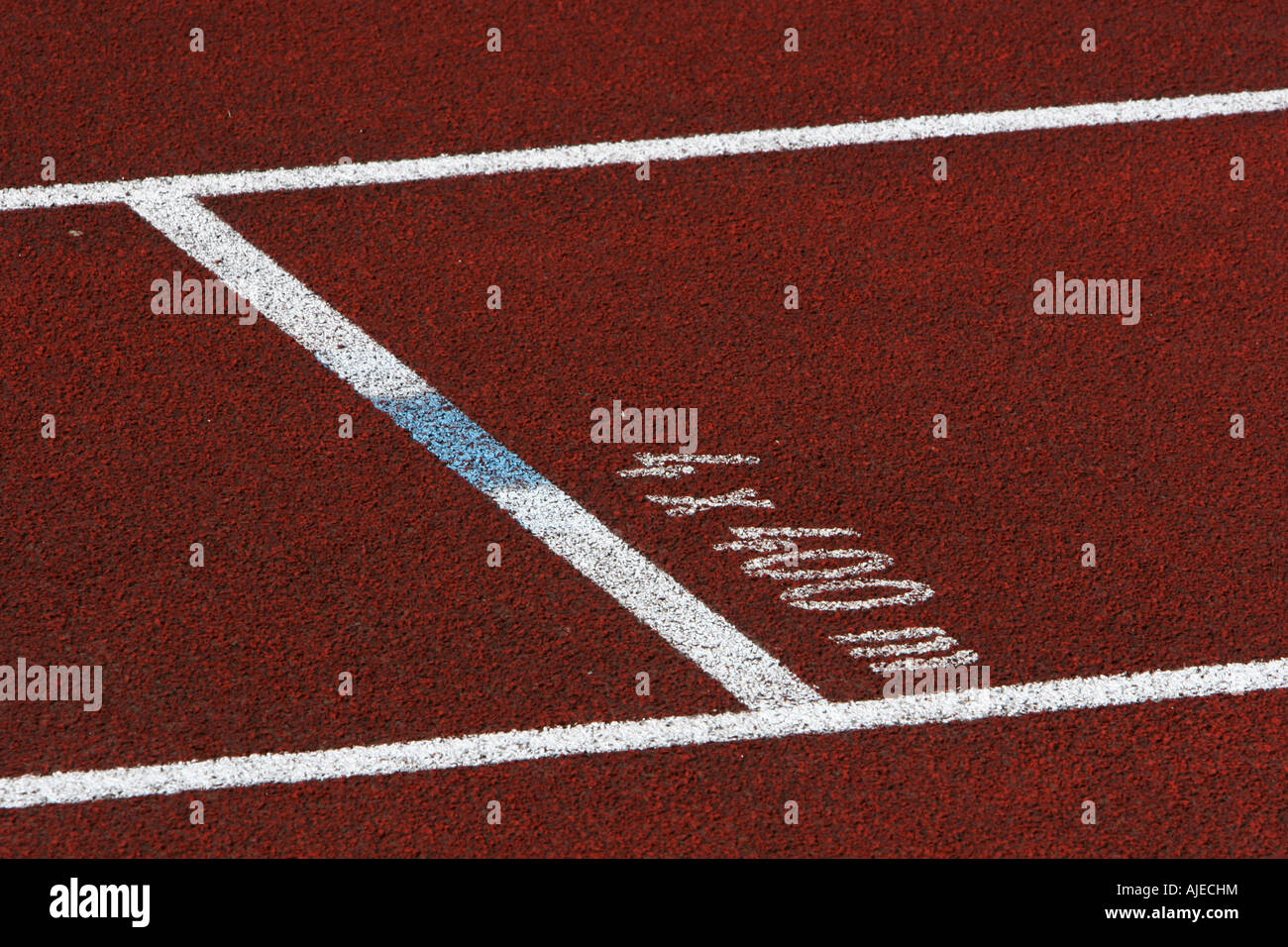Closeup of a single red track lane with 4x400m mark on the tarmack
