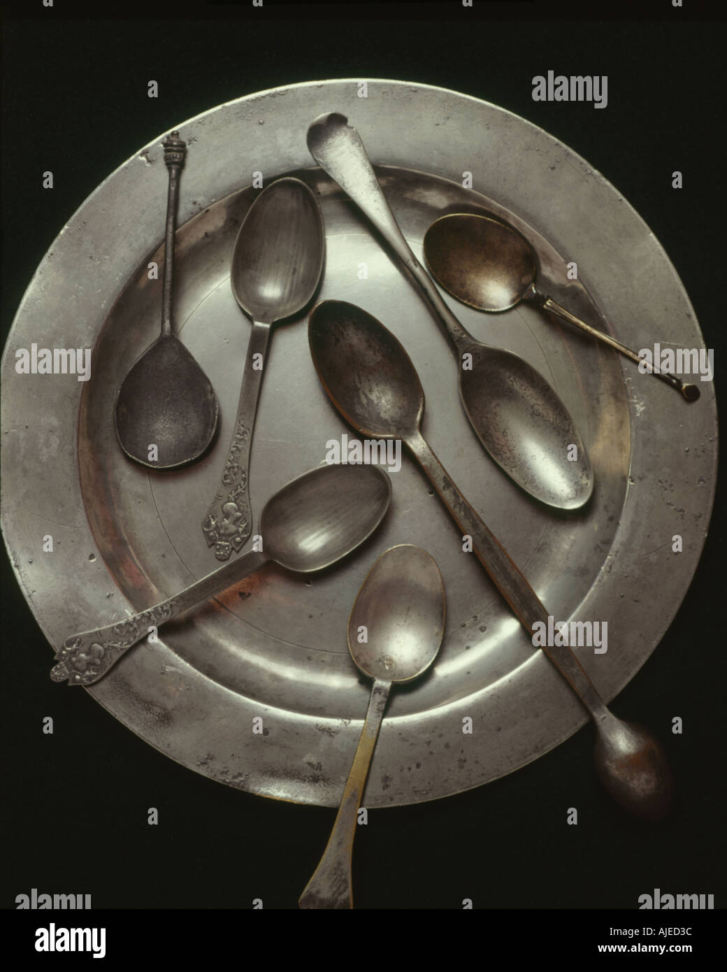 A plate and spoons from the extensive pewter collection of 400 items at