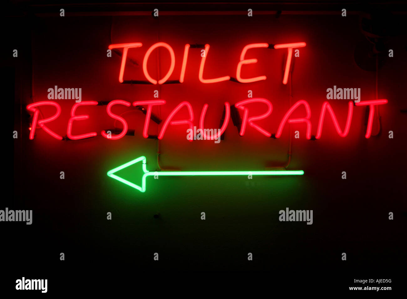 closeup of a badly worded neonsign in a restaurant Stock Photo
