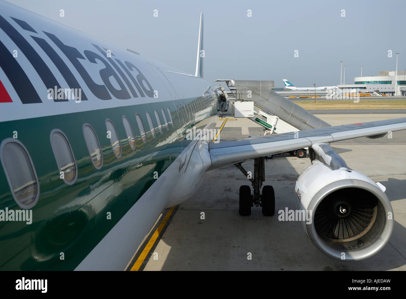 Embarking on a shiny green jet airplane in Milan Stock Photo