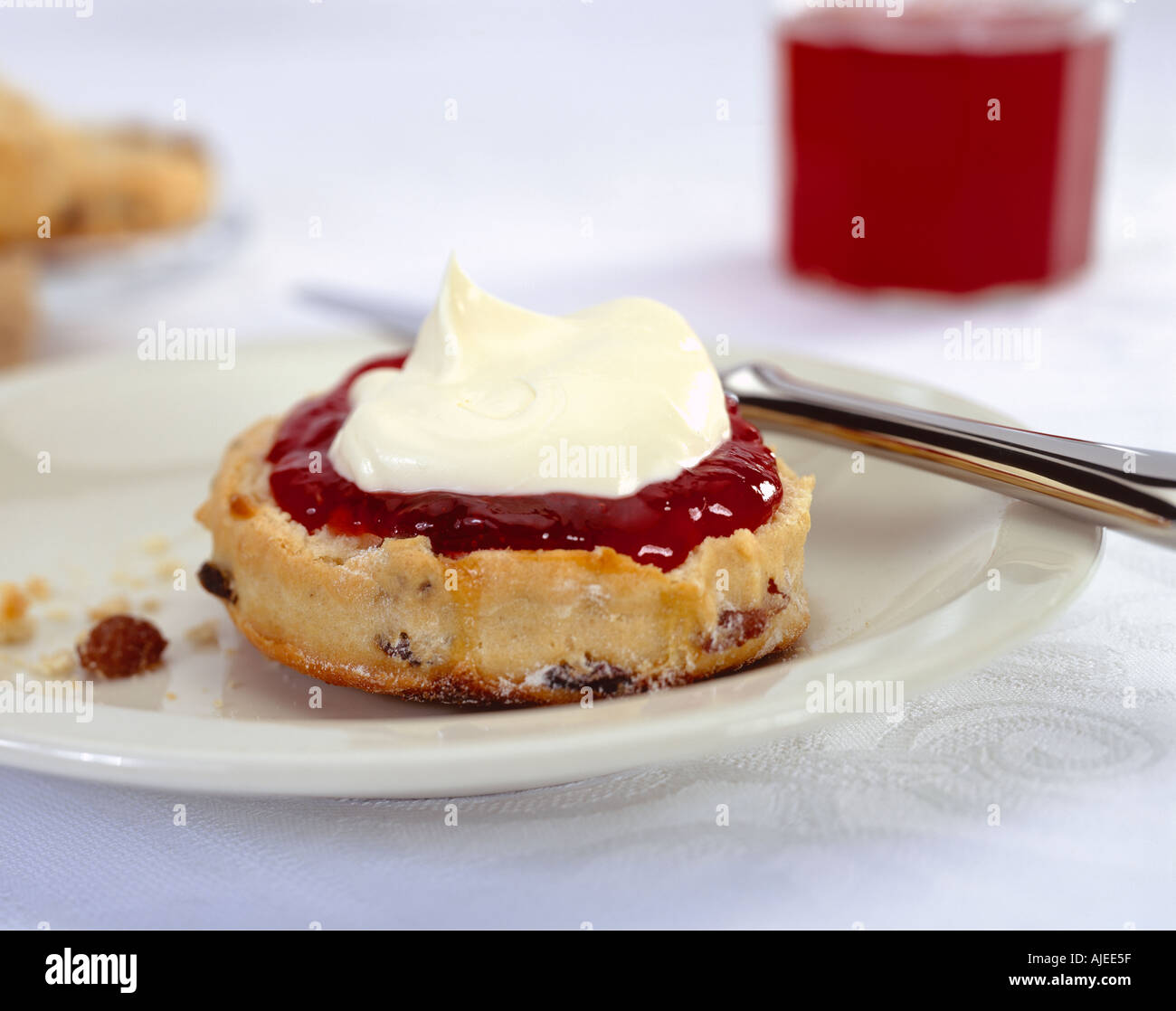 Afternoon tea a scone served on a plate with a generous helping of jam and cream Stock Photo Alamy