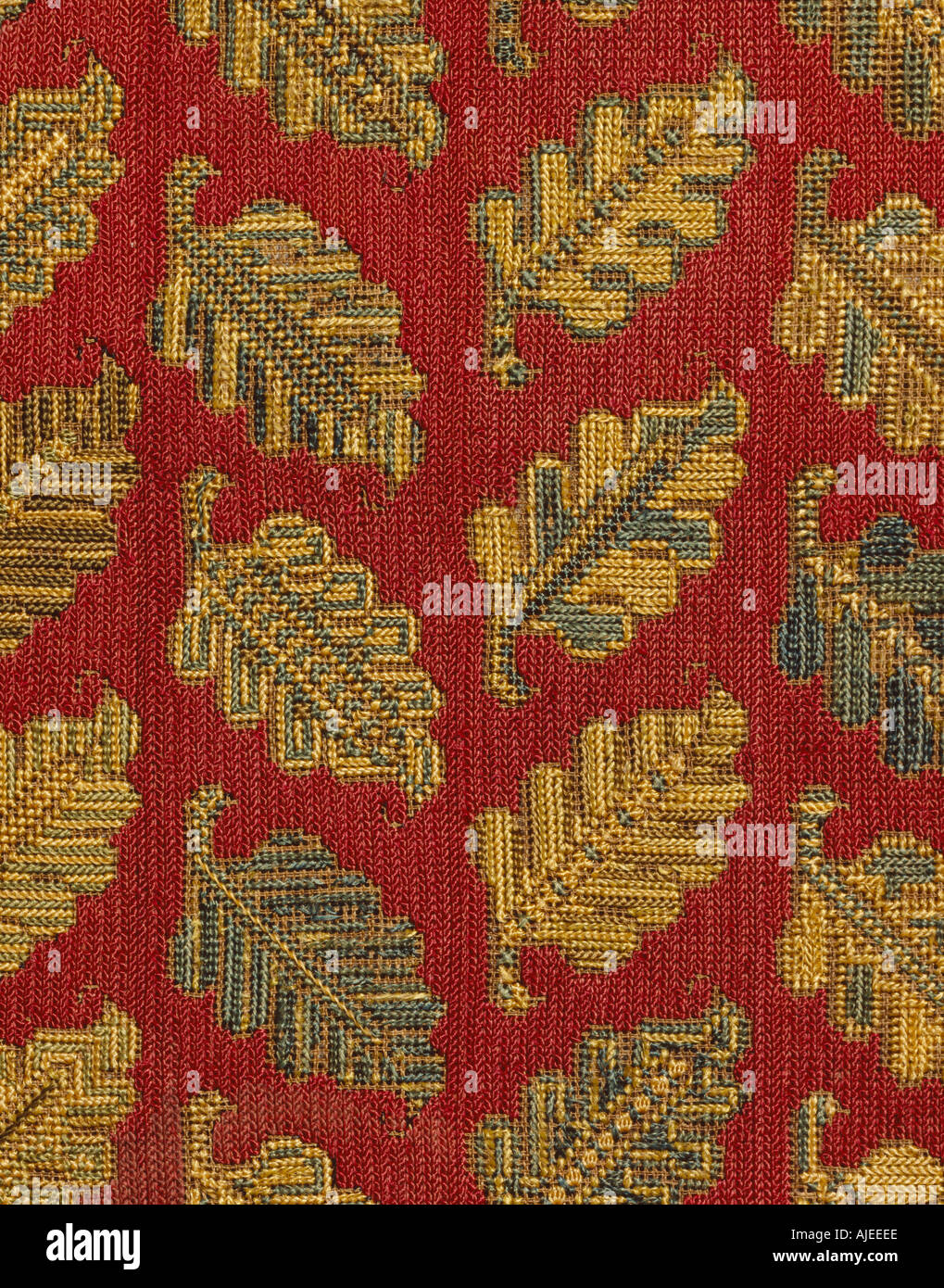 Detail of a framed cushion cover of crimson silk worked in long armed cross or tent stiches  at Hardwick Hall Derbyshire Stock Photo