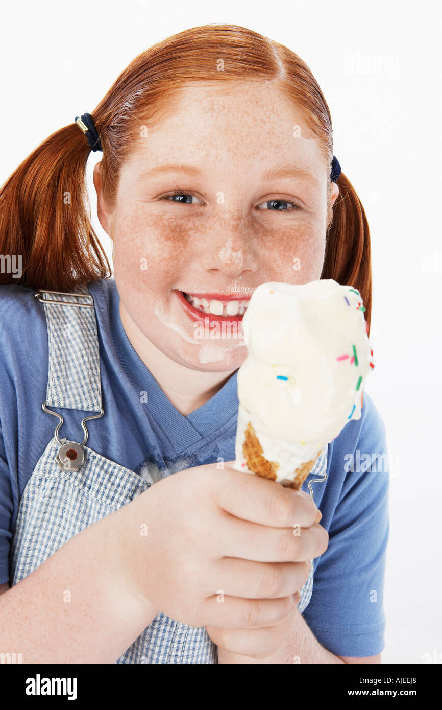 Overweight girl (1315) smiling, cream on face, holding ice cream cone