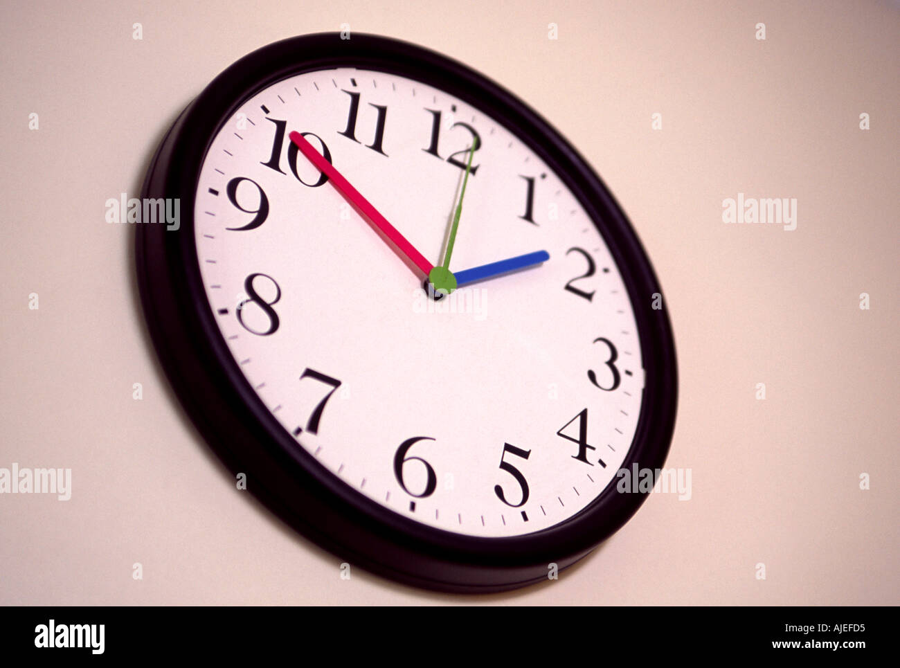 Telling the time: a wall clock; a studio shot. Stock Photo