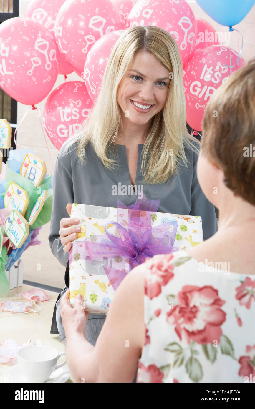 Woman Receiving a Gift at a Baby Shower Stock Photo Alamy