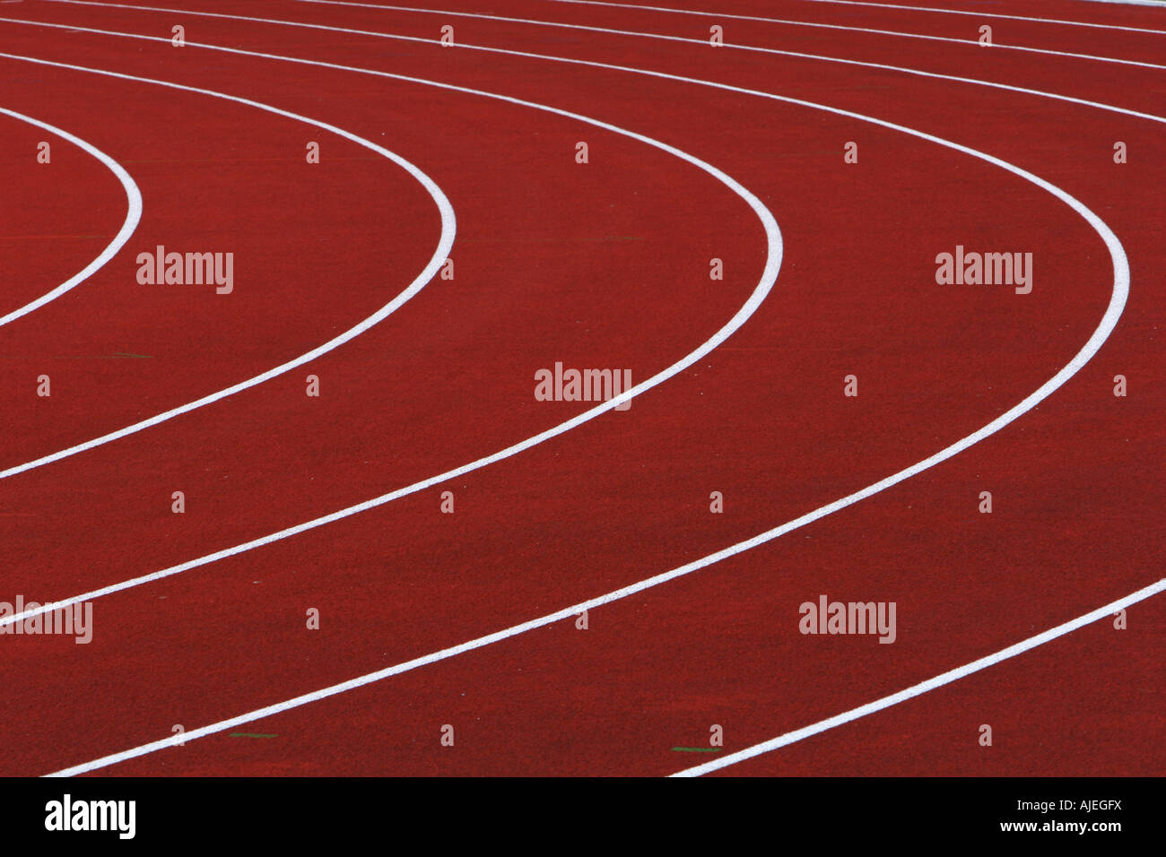 red running tracks with white dividing lines with a left hand turn