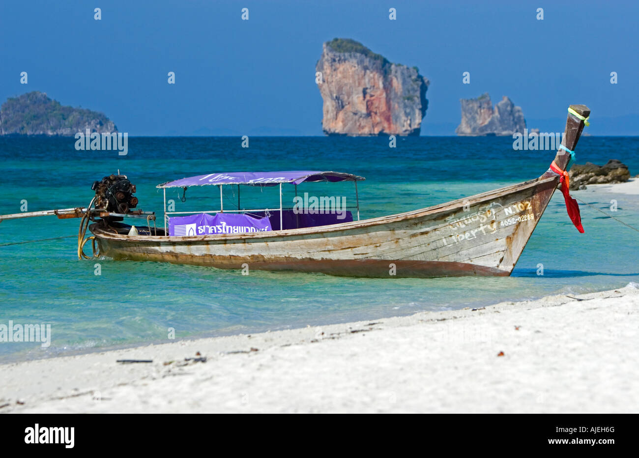 Longtail taxi boat on white sand beach of Ko Tup island near Ao Nang Thailand Stock Photo