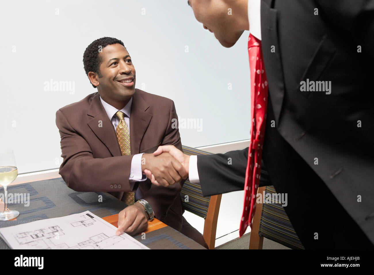 Two Businessmen Shaking Hands In Office Stock Photo - Alamy