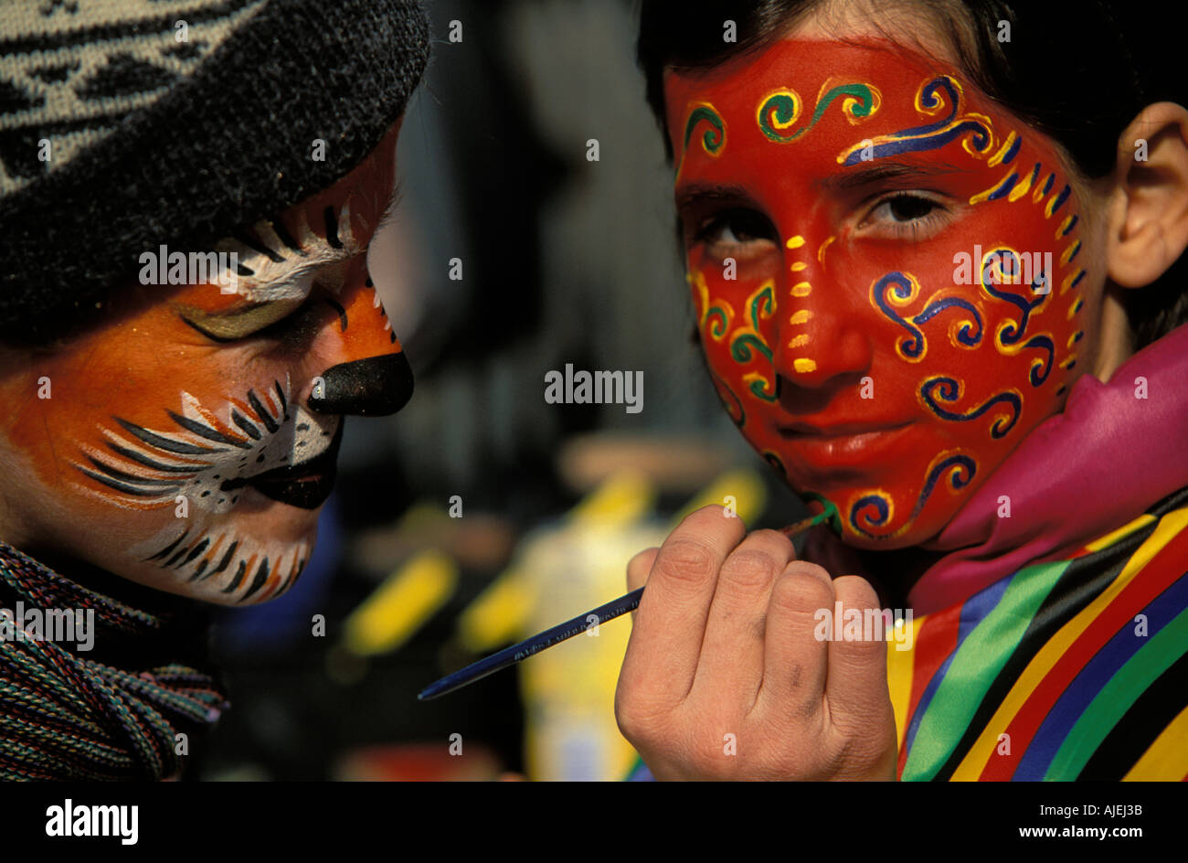 Venice a street artist paints a face mask Stock Photo